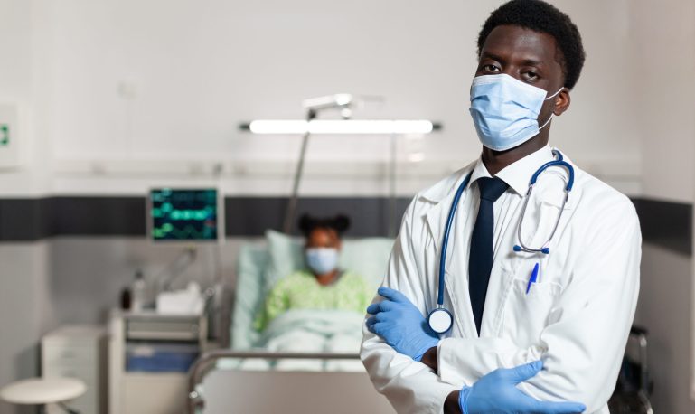 portrait of african american physician doctor with protection face mask to prevent infection with covid19